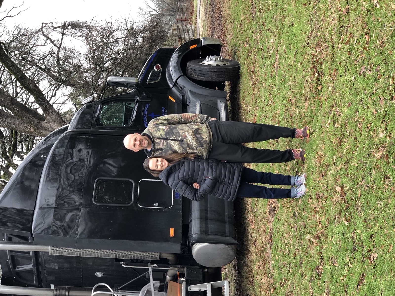Customers standing with a moving truck during a home transition